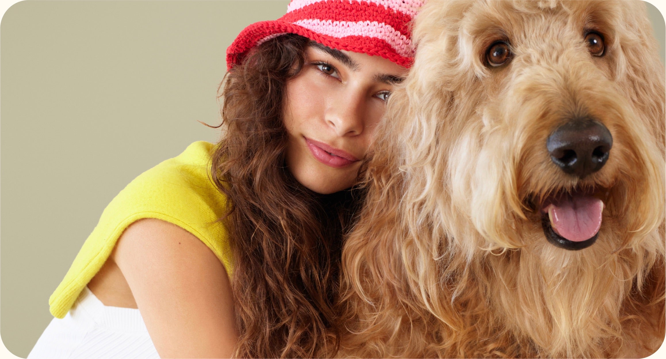 Woman wearing a red cap with a dog on a beige background
