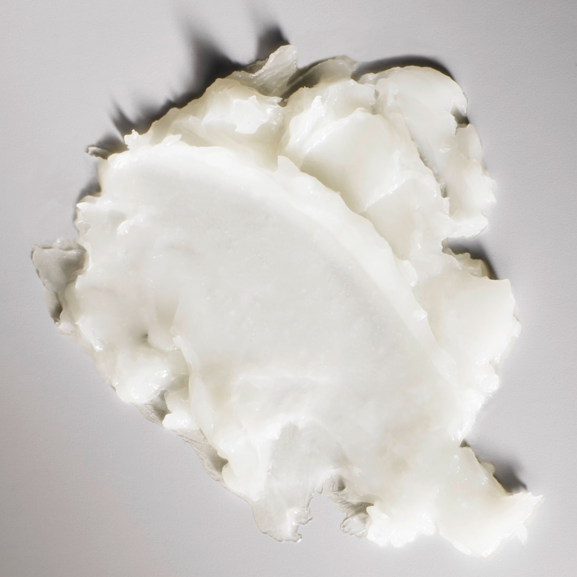 Close-up of a white, creamy substance on a gray background